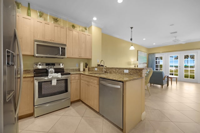 kitchen with light tile patterned floors, a peninsula, a sink, light brown cabinetry, and stainless steel appliances