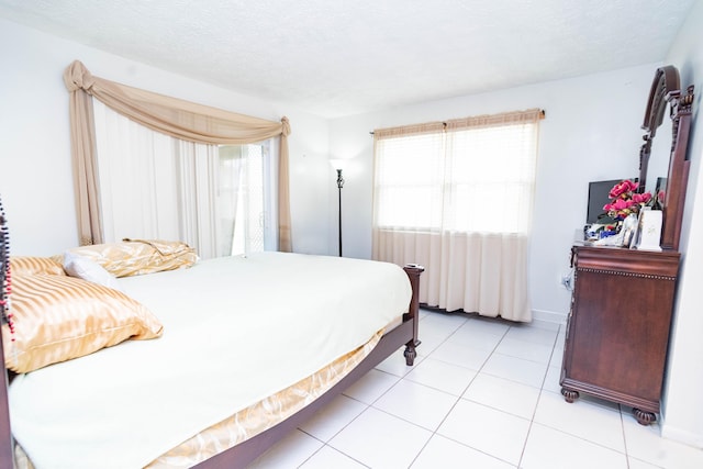 885 SW Canary Ter, Port Saint Lucie, FL 34953 - bedroom with multiple windows, baseboards, light tile patterned floors, and a textured ceiling