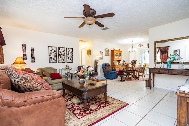 885 SW Canary Ter, Port Saint Lucie, FL 34953 - living area with light tile patterned flooring, ceiling fan with notable chandelier, a textured ceiling, and visible vents
