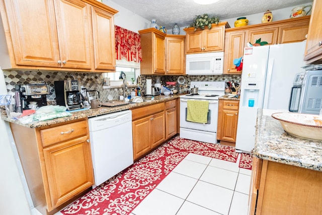 885 SW Canary Ter, Port Saint Lucie, FL 34953 - kitchen featuring decorative backsplash, a textured ceiling, light tile patterned floors, and white appliances