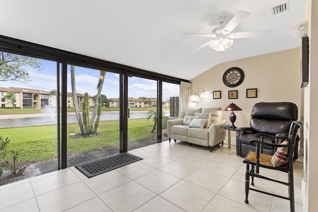 sunroom with visible vents, a ceiling fan, lofted ceiling, and a water view