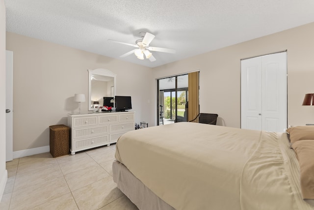 bedroom featuring access to exterior, baseboards, light tile patterned floors, a textured ceiling, and a ceiling fan