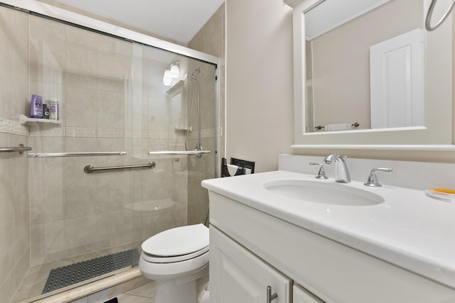 full bathroom featuring vanity, a shower stall, toilet, and tile patterned floors