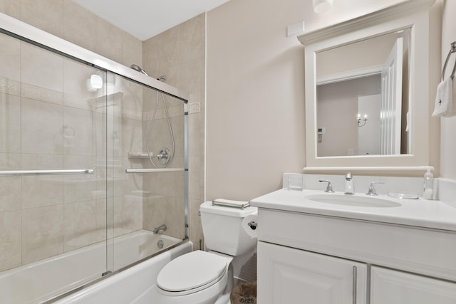 full bathroom featuring combined bath / shower with glass door, toilet, and vanity