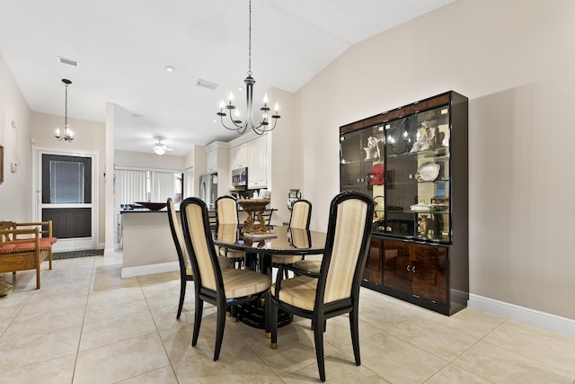 dining area featuring light tile patterned floors, visible vents, baseboards, and lofted ceiling