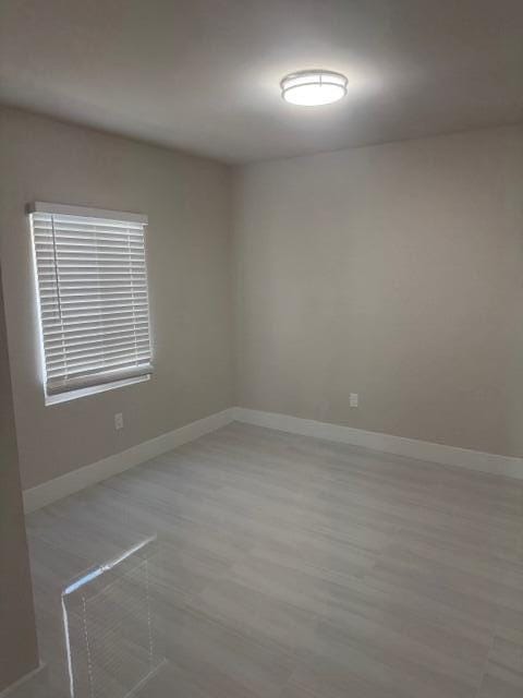 spare room with baseboards