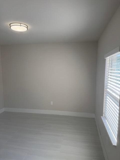 spare room with baseboards