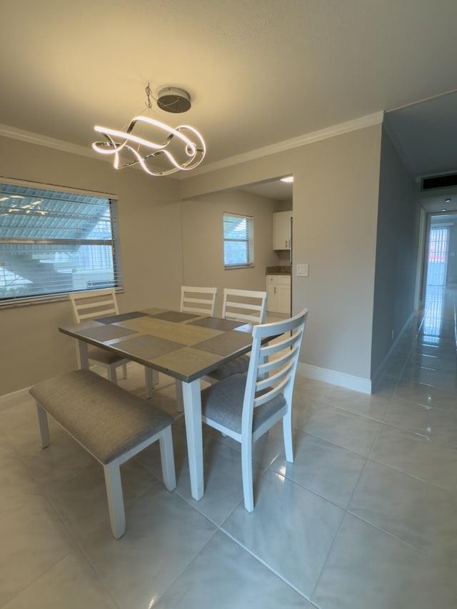 dining area with visible vents, light tile patterned flooring, crown molding, baseboards, and a chandelier