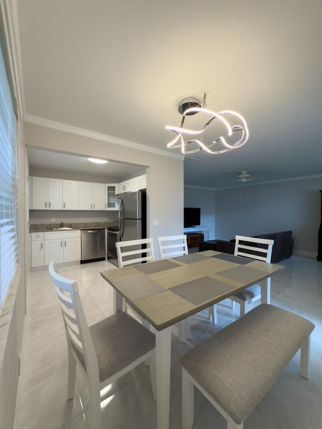 dining room featuring a notable chandelier and ornamental molding