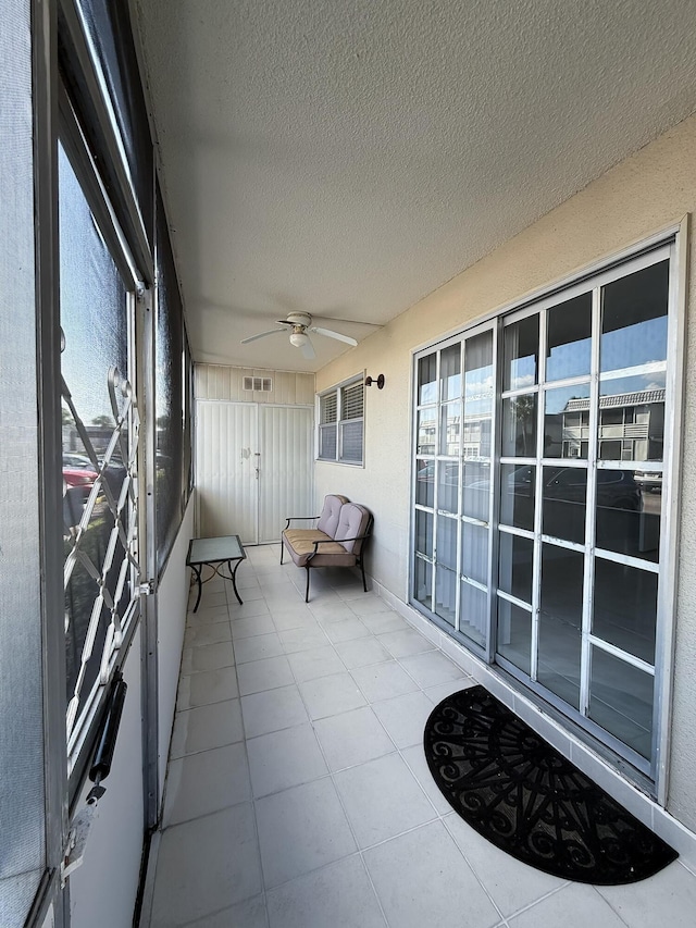 unfurnished sunroom with visible vents and ceiling fan