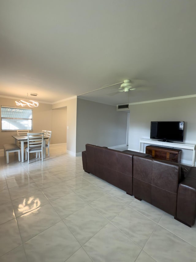 unfurnished living room with visible vents, baseboards, a ceiling fan, and ornamental molding