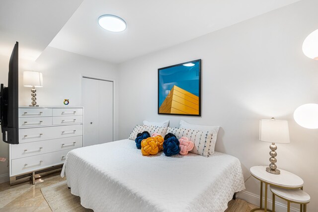 bedroom with a closet and baseboards