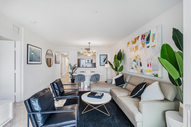 living area featuring visible vents, baseboards, and an inviting chandelier