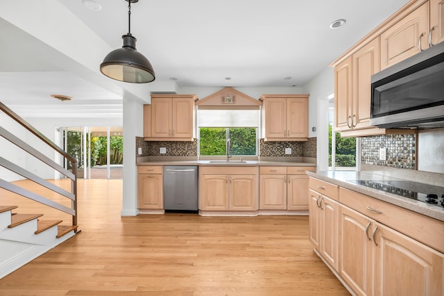 2601 NE 37th St, Fort Lauderdale, FL 33306 - kitchen with appliances with stainless steel finishes, light brown cabinets, a sink, light countertops, and light wood-type flooring