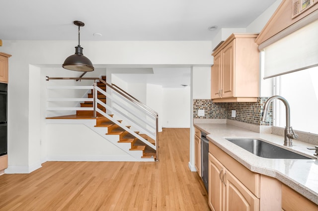 2601 NE 37th St, Fort Lauderdale, FL 33306 - kitchen featuring light brown cabinetry, a sink, light wood-type flooring, and tasteful backsplash
