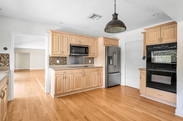 2601 NE 37th St, Fort Lauderdale, FL 33306 - kitchen with black appliances, light brown cabinets, light countertops, decorative backsplash, and recessed lighting