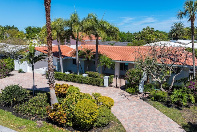 2601 NE 37th St, Fort Lauderdale, FL 33306 - mediterranean / spanish house featuring a tile roof, decorative driveway, and stucco siding