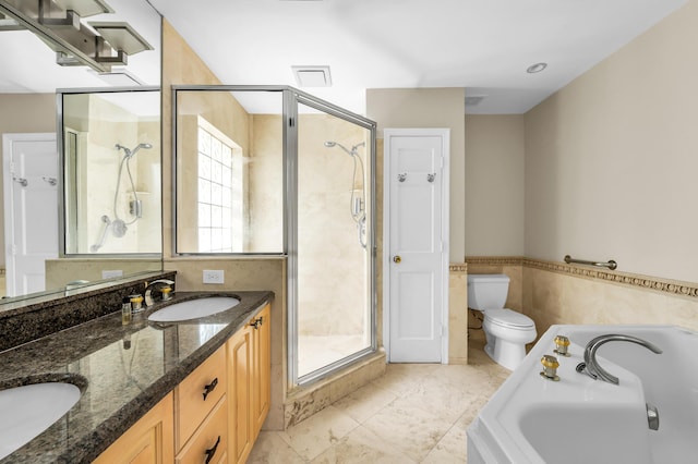 2601 NE 37th St, Fort Lauderdale, FL 33306 - bathroom with a garden tub, a stall shower, toilet, double vanity, and wainscoting