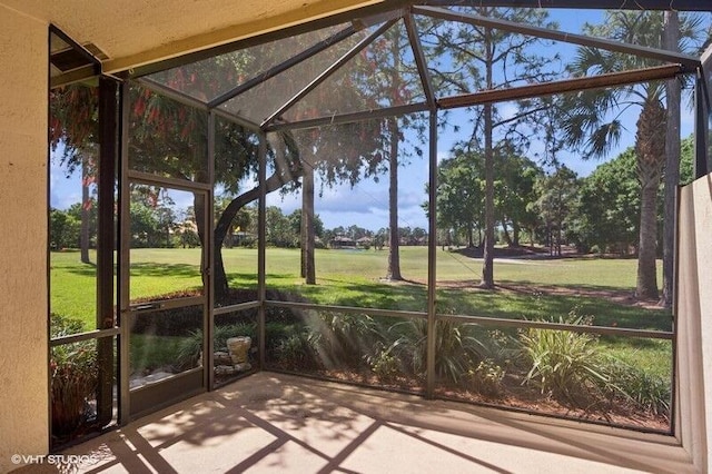 unfurnished sunroom featuring lofted ceiling