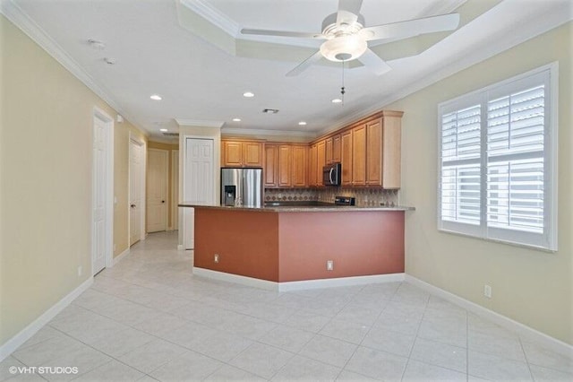 kitchen with decorative backsplash, appliances with stainless steel finishes, baseboards, and ornamental molding