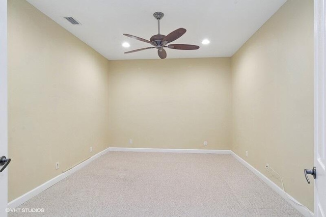 unfurnished room with a ceiling fan, baseboards, visible vents, and light carpet