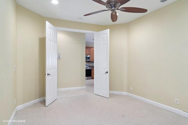 unfurnished bedroom with light carpet, visible vents, and baseboards