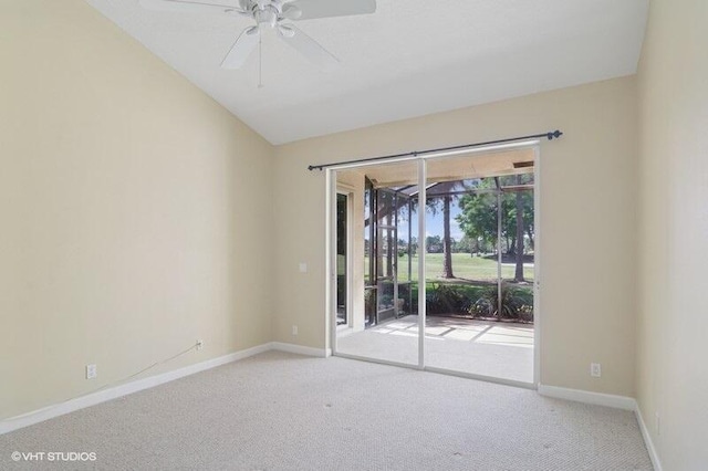 carpeted spare room featuring ceiling fan, baseboards, and vaulted ceiling