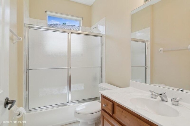 full bath featuring vanity, toilet, and enclosed tub / shower combo