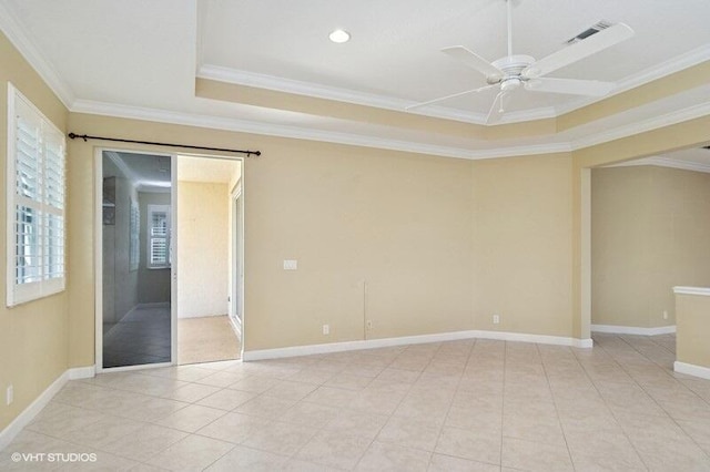 spare room with visible vents, baseboards, ornamental molding, light tile patterned flooring, and a ceiling fan