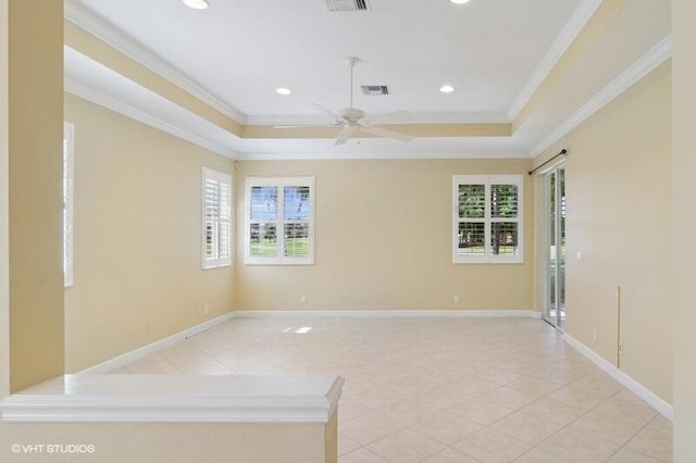 unfurnished room with visible vents, crown molding, baseboards, a tray ceiling, and recessed lighting