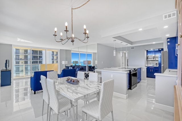 dining space featuring light tile patterned floors, visible vents, and expansive windows