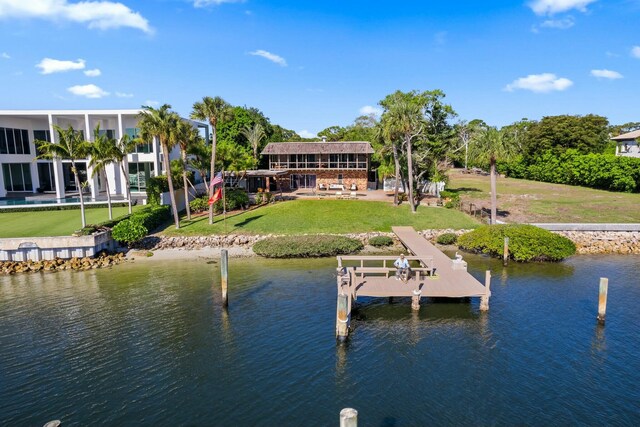 rear view of property featuring a patio, fence, a yard, an outdoor pool, and a sunroom