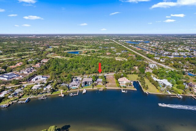 drone / aerial view with a view of trees and a water view