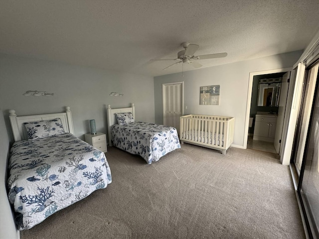 carpeted bedroom featuring a closet, a textured ceiling, and a ceiling fan