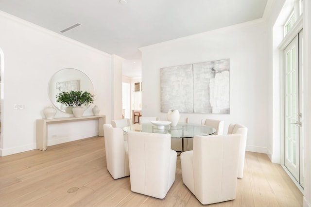 205 Gray St, West Palm Beach, FL 33405 - dining space with light wood-style flooring, healthy amount of natural light, and crown molding