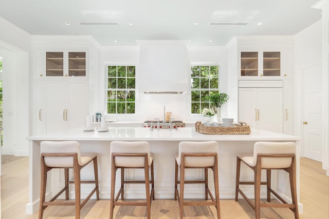 205 Gray St, West Palm Beach, FL 33405 - kitchen with a kitchen bar, white cabinets, glass insert cabinets, and recessed lighting
