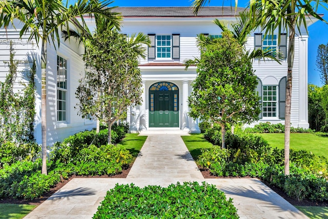 entrance to property featuring a lawn