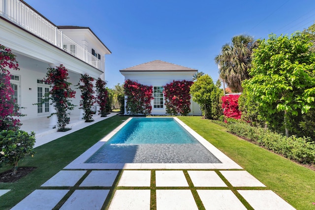 pool featuring a yard and a patio area