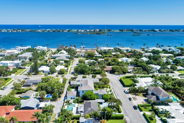 drone / aerial view featuring a residential view and a water view