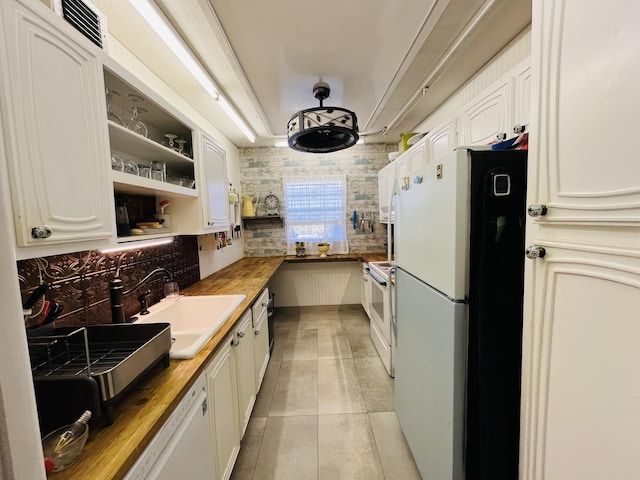 kitchen featuring visible vents, decorative backsplash, light tile patterned flooring, white appliances, and a sink