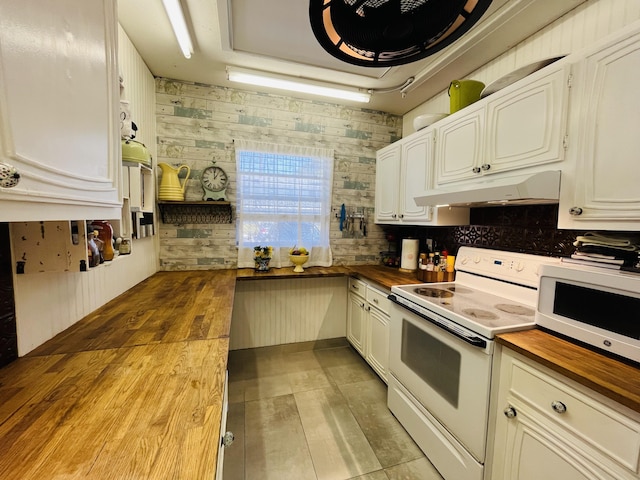 kitchen with under cabinet range hood, butcher block counters, light wood-style flooring, white cabinets, and white appliances