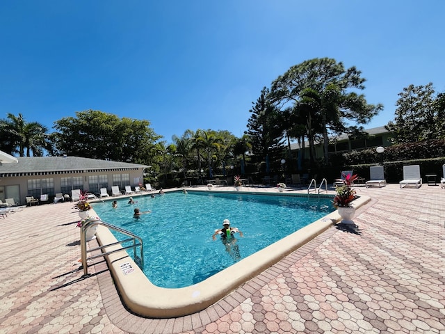 pool featuring a patio and fence