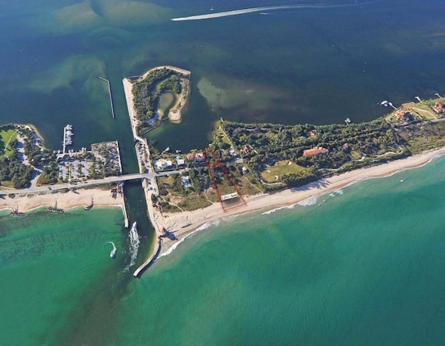 birds eye view of property featuring a view of the beach and a water view