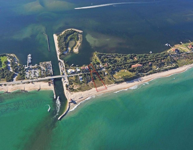 birds eye view of property with a beach view and a water view