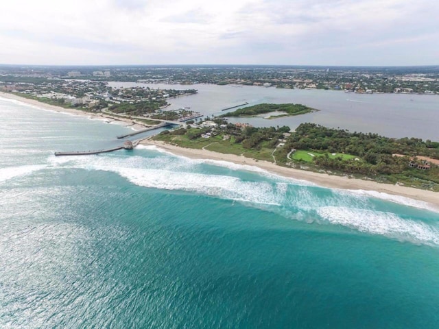 bird's eye view featuring a view of the beach and a water view