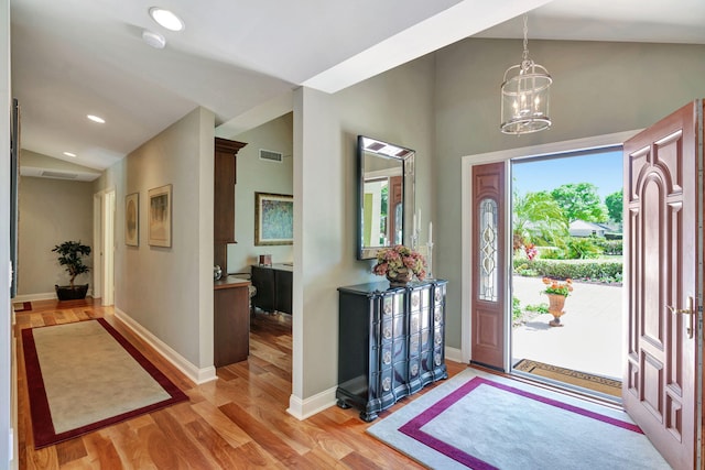 entryway featuring light wood-type flooring, visible vents, recessed lighting, baseboards, and lofted ceiling