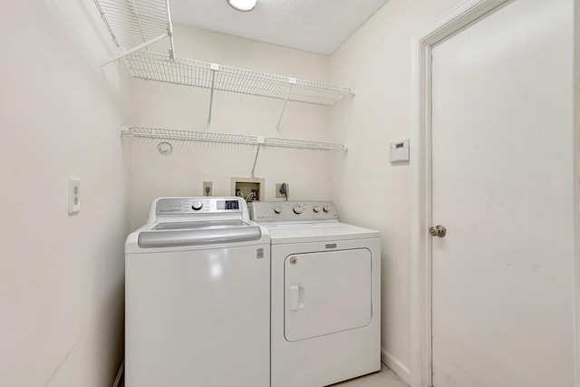 laundry room with washer and clothes dryer and laundry area