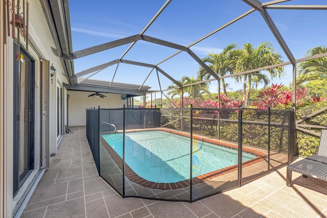 pool with a patio area and glass enclosure