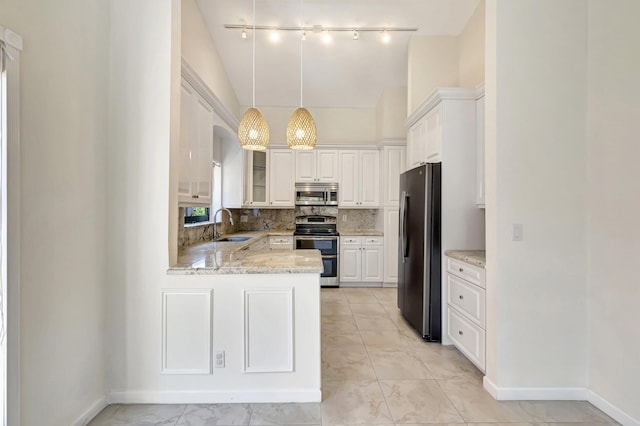 kitchen featuring backsplash, a peninsula, marble finish floor, stainless steel appliances, and a sink