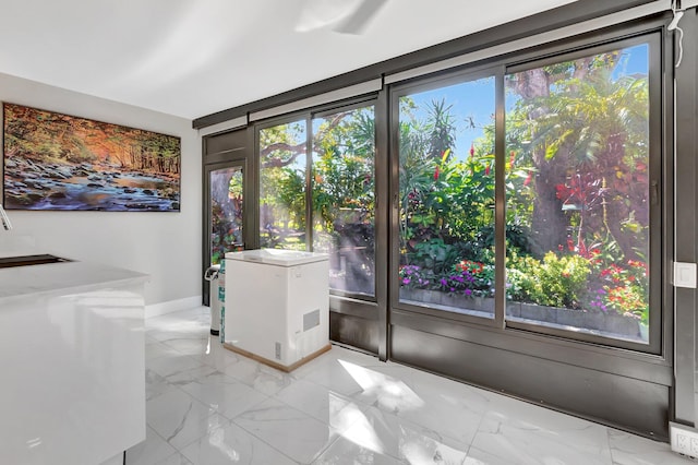 interior space with marble finish floor and baseboards